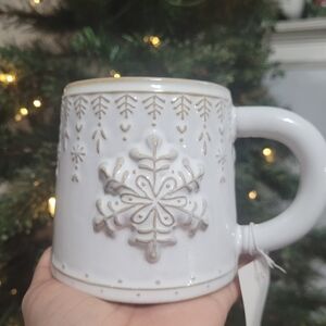 White stoneware coffee mug with a Christmas snowflake design.